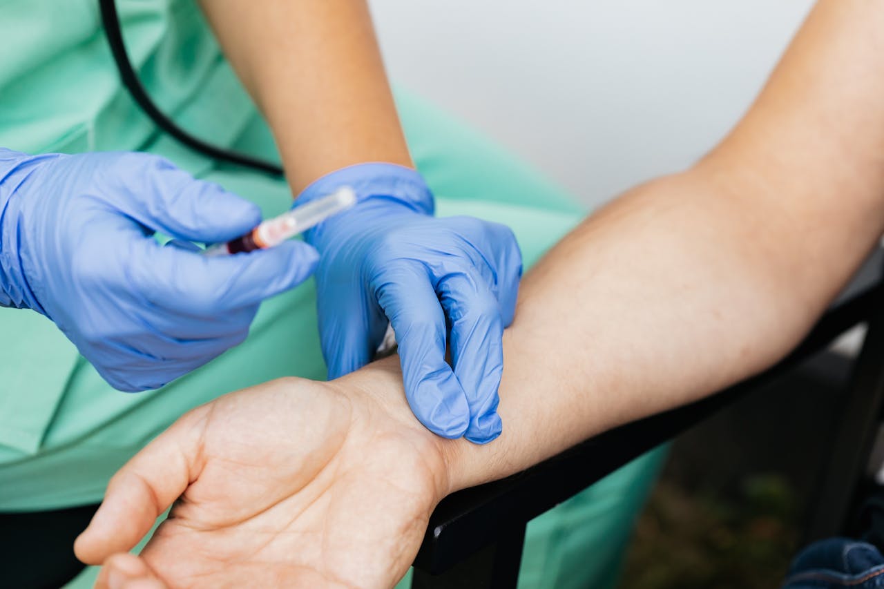 The Art of Drawing Readers In: Your attractive post title goes here Close-up of nurse checking pulse and preparing syringe for medical use.
